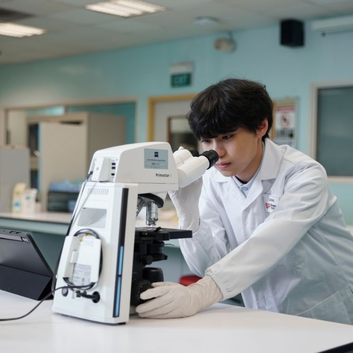 CLS-DCPS Student Observing Samples Through Microscope-v01