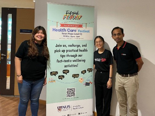 Students taking a photo with a poster