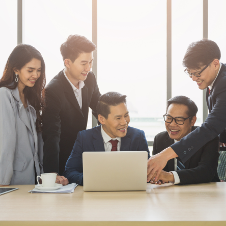 Group pointing at computer