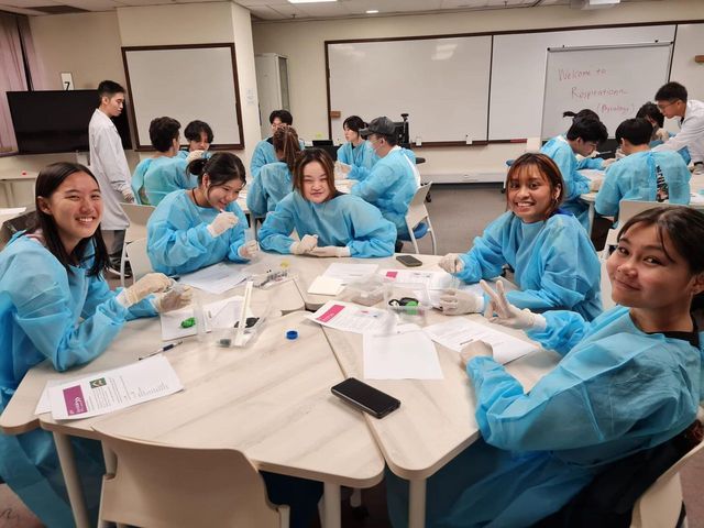 Students seated in a group within a lab