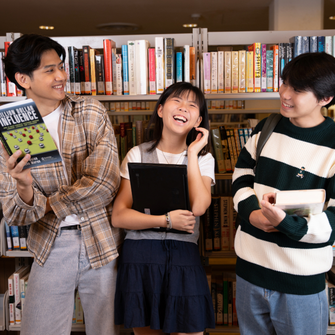 Three people in a library