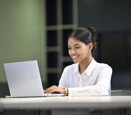 SB-DAC Student Smiling While Looking at Their Laptop-v01