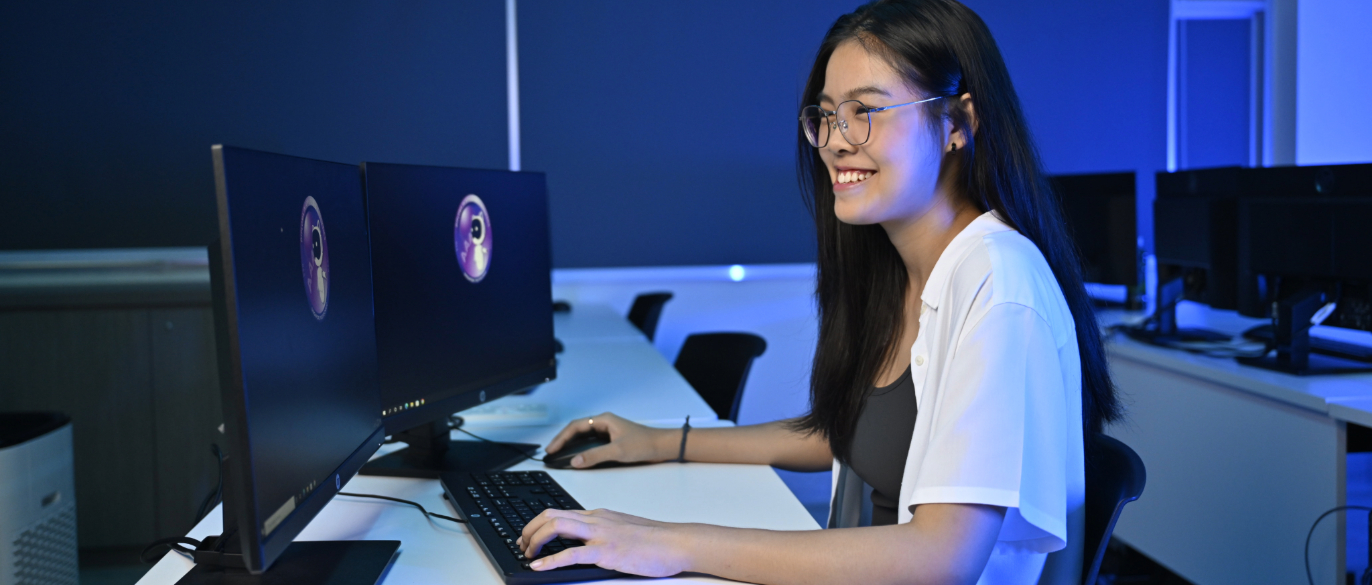 SOC-DCITP Student Looking at Astrobot on Two Monitors