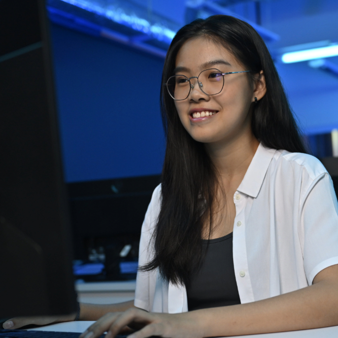 SOC-DIT Student Working at Laptop